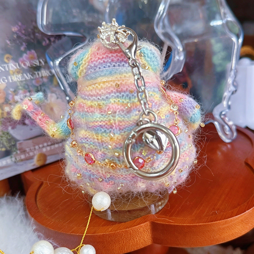 Rainbow Charm Toad – Hand-Knitted Bag Charm with Silver Crystal Crown, Ruby Necklace, Pink Tulle Bow &amp; Pearl Tassel | The Third Space