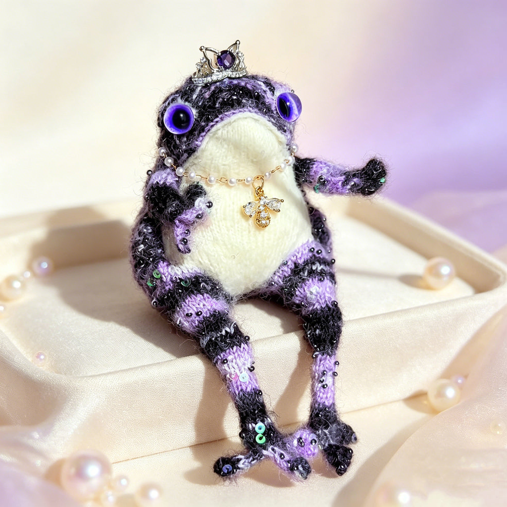 Sapphire-Eyed Mystic Toad – Hand-Knitted Figurine with Silver Crown, Purple Heart Gem, Pearl Necklace, Golden Bee Pendant &amp; Sequin Accents | The Third Space