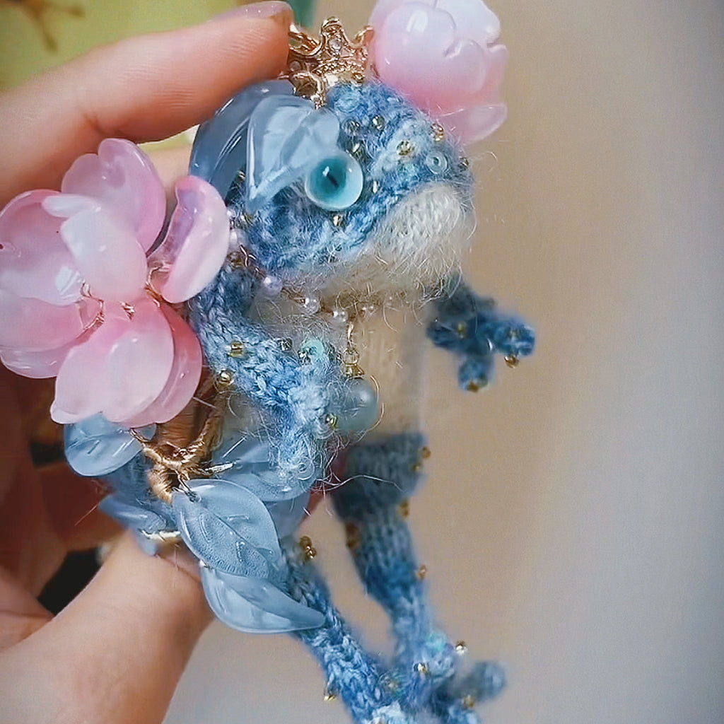 The Flower-Crowned Forest Prince – Hand-Knitted Miniature Toad Charm with Gold Crown, Blue Glass Eyes, Pink Blossoms, Pearl Necklace &amp; Sequin-Toed Limbs | The Third Space