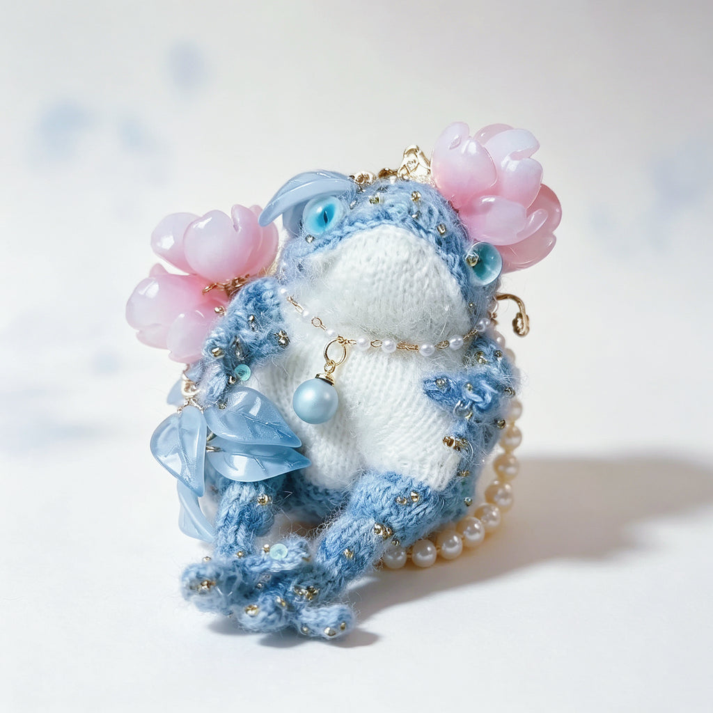 The Flower-Crowned Forest Prince – Hand-Knitted Miniature Toad Charm with Gold Crown, Blue Glass Eyes, Pink Blossoms, Pearl Necklace &amp; Sequin-Toed Limbs | The Third Space
