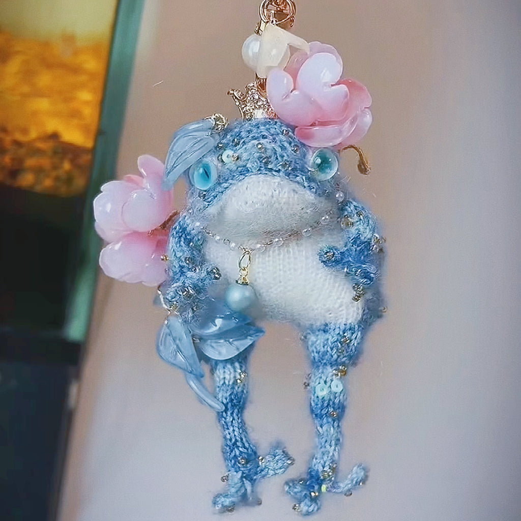 The Flower-Crowned Forest Prince – Hand-Knitted Miniature Toad Charm with Gold Crown, Blue Glass Eyes, Pink Blossoms, Pearl Necklace &amp; Sequin-Toed Limbs | The Third Space