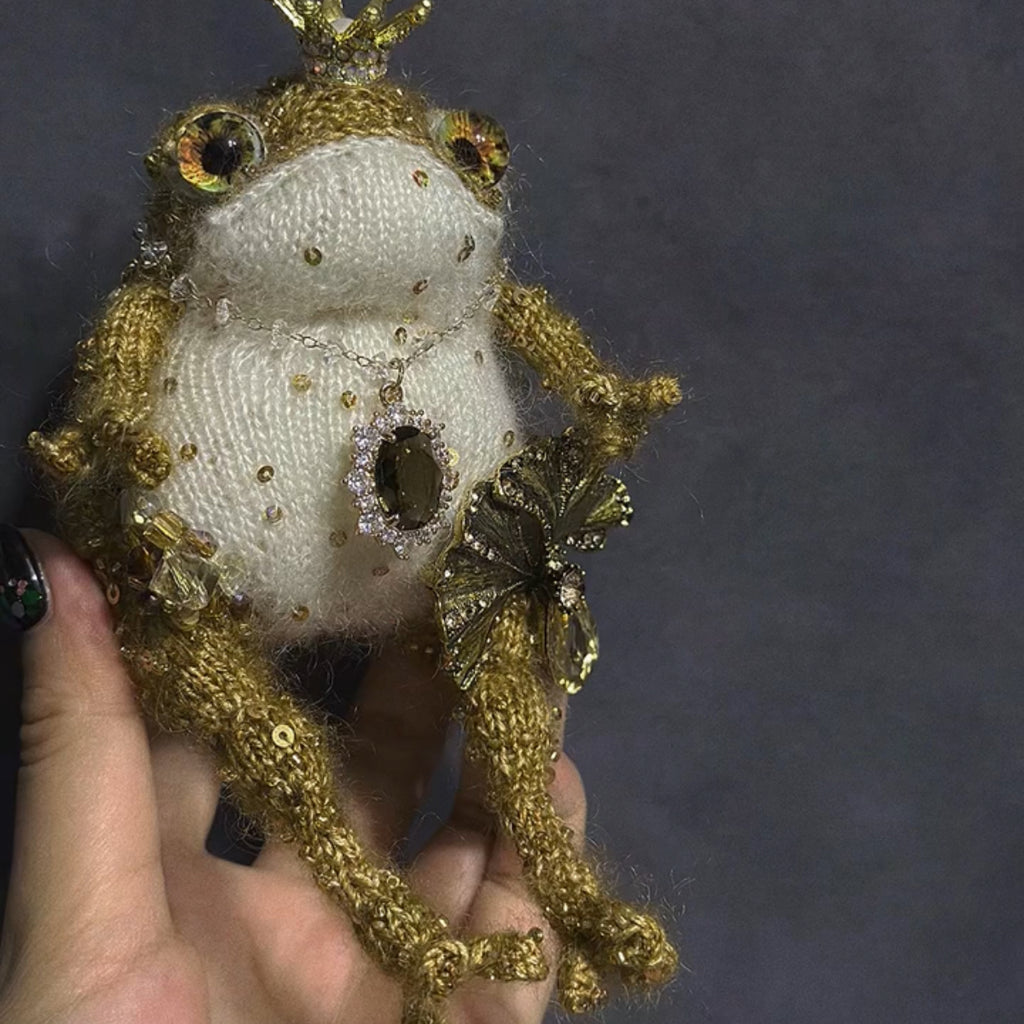 The Golden Frog Prince – Hand-Knitted Royal Charm with Mini Crown, Jewel Eyes, Gemstone Belly, Golden Limbs, Bow Accent &amp; Hanging Loop | The Third Space