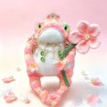 The Toad Princess of the Fairy-Tale Garden – Hand-Knitted Pink Figurine with Mini Crown, Crystal &amp; Emerald Necklace, Pearl-Center Flower &amp; Sequin-Sparkled Limbs | The Third Space