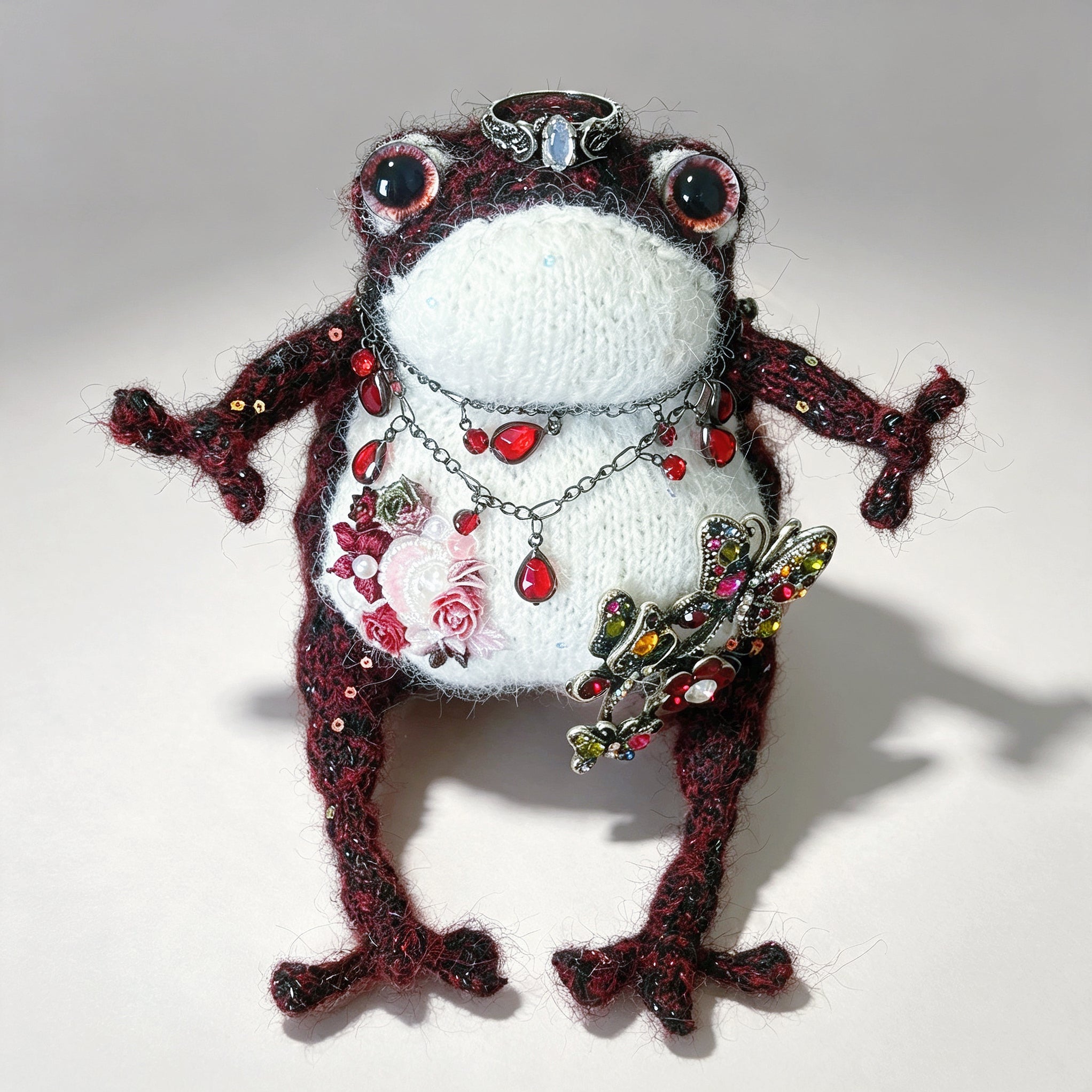 The Gothic Jewel Toad – Hand-Knitted Figurine in Deep Red &amp; Black Sparkle Yarn, Silver Crown, Ruby Teardrop Necklace, Crystal Butterfly Brooch &amp; Embroidered Flowers | The Third Space