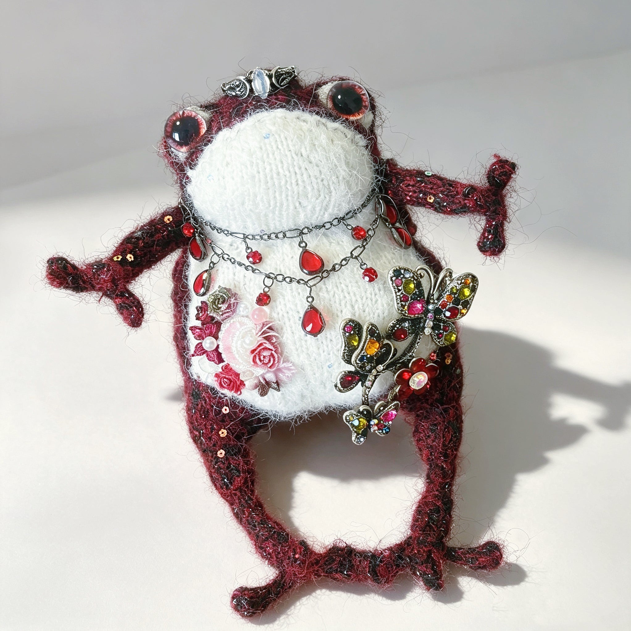 The Gothic Jewel Toad – Hand-Knitted Figurine in Deep Red &amp; Black Sparkle Yarn, Silver Crown, Ruby Teardrop Necklace, Crystal Butterfly Brooch &amp; Embroidered Flowers | The Third Space