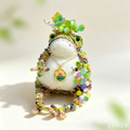 The Grape-Gathering Toad – Hand-Knitted Figurine with Plump White Belly, Green Bead Vine Crown, Colorful Bead Tassels, Floral Round Pendant &amp; Mossy Green-Yellow-Brown Yarn Texture | The Third Space